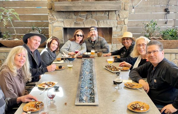 a group of people sitting at a table eating food