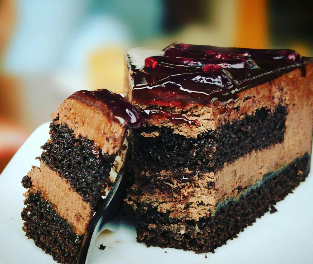 a close up of a piece of chocolate cake on a plate